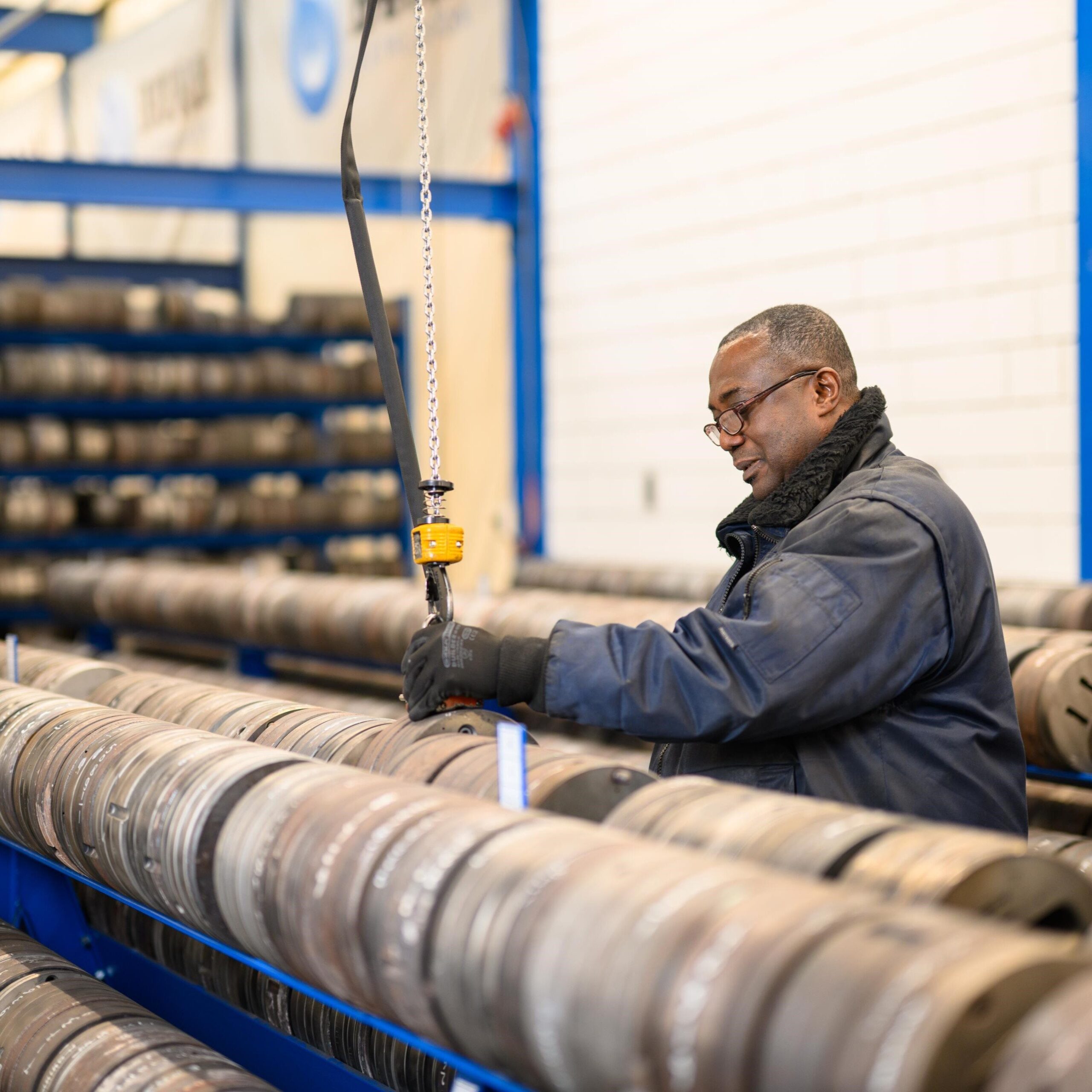 BOAL production worker handling industrial aluminium-processing machinery in a factory